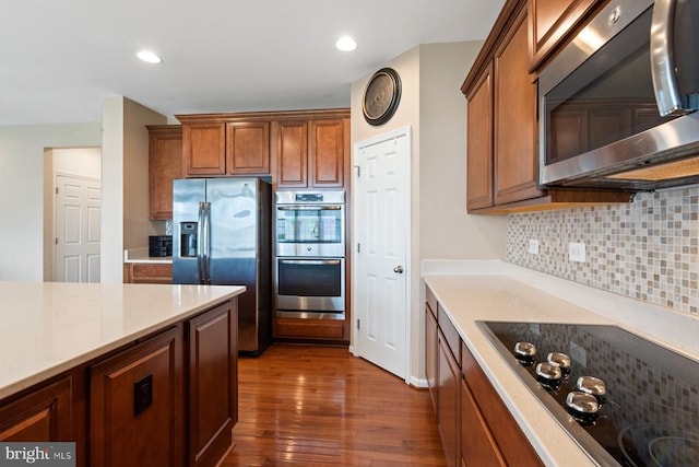 5505 Spring Bluff Ct, Fredericksburg, VA 22407 - kitchen featuring appliances with stainless steel finishes, decorative backsplash, dark wood-style floors, light countertops, and recessed lighting