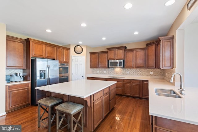 5505 Spring Bluff Ct, Fredericksburg, VA 22407 - kitchen with appliances with stainless steel finishes, a sink, a center island, dark wood finished floors, and recessed lighting