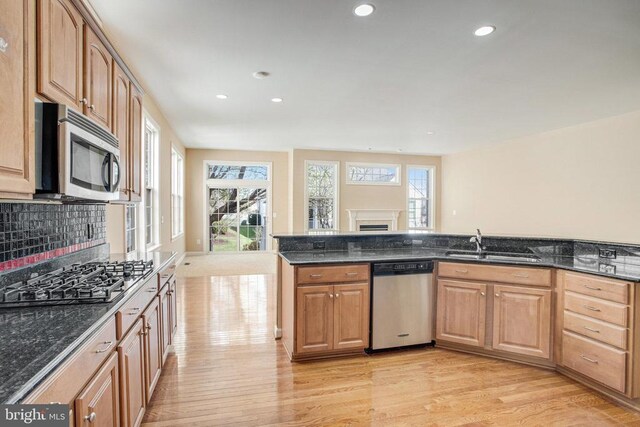 5409 Rich Mountain Way E, Fredericksburg, VA 22407 - kitchen featuring stainless steel appliances, a sink, light wood-style floors, recessed lighting, and dark stone counters