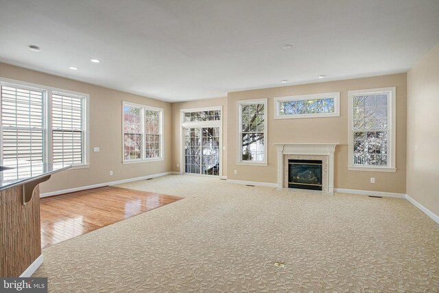 5409 Rich Mountain Way E, Fredericksburg, VA 22407 - unfurnished living room featuring baseboards, a premium fireplace, plenty of natural light, carpet floors, and recessed lighting