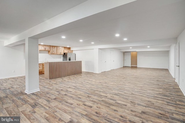 5409 Rich Mountain Way E, Fredericksburg, VA 22407 - finished below grade area with stainless steel refrigerator with ice dispenser, wood finished floors, recessed lighting, and baseboards