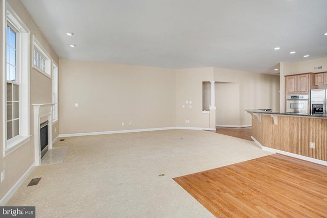 5409 Rich Mountain Way E, Fredericksburg, VA 22407 - unfurnished living room featuring recessed lighting, baseboards, a high end fireplace, and light colored carpet