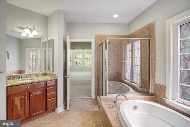 5409 Rich Mountain Way E, Fredericksburg, VA 22407 - full bathroom featuring a stall shower, vanity, a bath, tile patterned floors, and baseboards