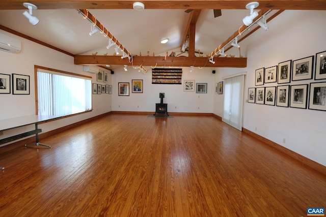 2256 Adial Rd, Faber, VA 22938 - unfurnished living room featuring a wood stove, an AC wall unit, beamed ceiling, and wood finished floors