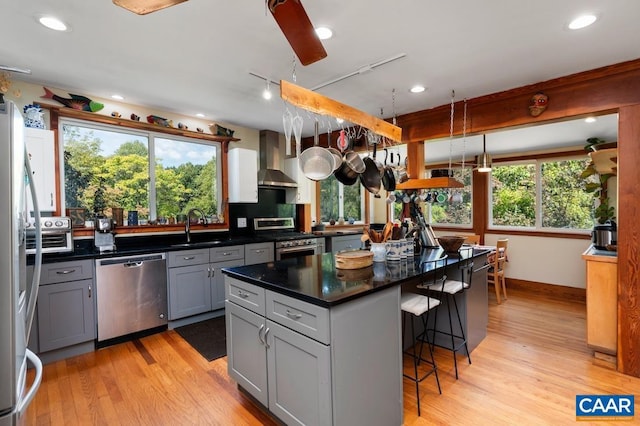 2256 Adial Rd, Faber, VA 22938 - kitchen with a sink, wall chimney exhaust hood, stainless steel appliances, a kitchen breakfast bar, and gray cabinets
