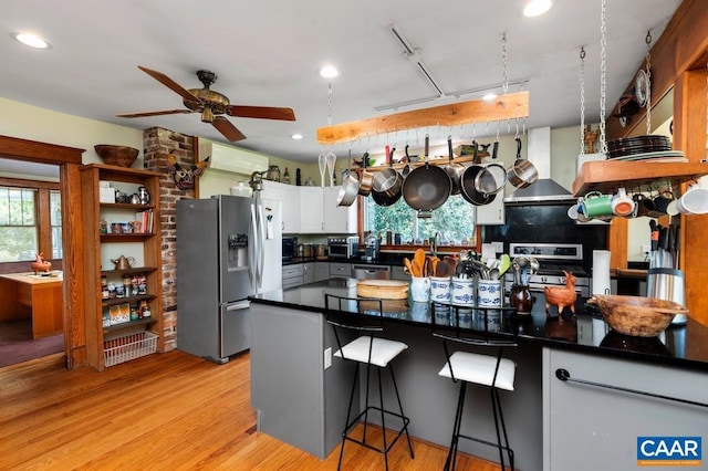 2256 Adial Rd, Faber, VA 22938 - kitchen with appliances with stainless steel finishes, a ceiling fan, a healthy amount of sunlight, and wall chimney exhaust hood