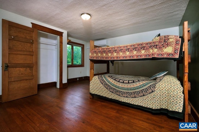 2256 Adial Rd, Faber, VA 22938 - bedroom featuring a wall mounted air conditioner, a textured ceiling, wood finished floors, and baseboards