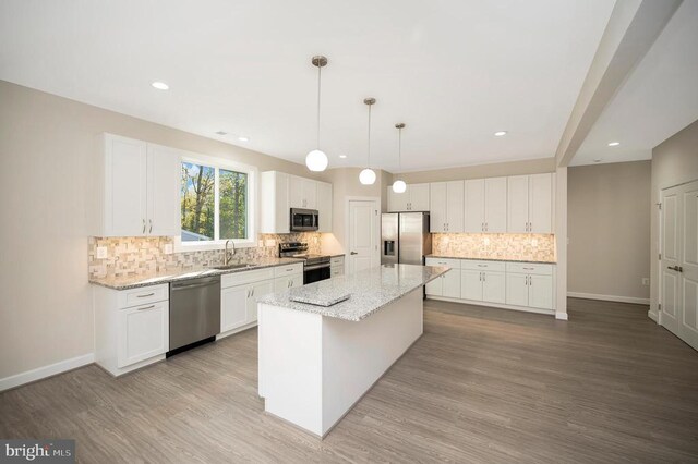400 Constitution Blvd, Locust Grove, VA 22508 - kitchen featuring appliances with stainless steel finishes, a sink, light wood-style flooring, white cabinetry, and recessed lighting