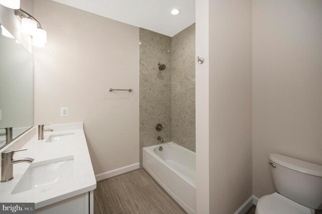 400 Constitution Blvd, Locust Grove, VA 22508 - bathroom with baseboards, toilet, wood finished floors, double vanity, and  shower combination