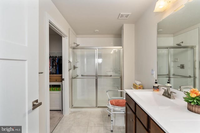 35079 Orchid Ln, Locust Grove, VA 22508 - full bathroom with a shower stall, vanity, tile patterned flooring, and a spacious closet