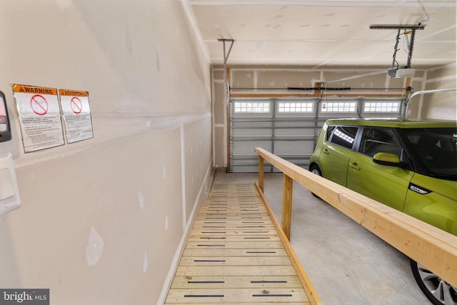 35079 Orchid Ln, Locust Grove, VA 22508 - garage featuring baseboards and a garage door opener