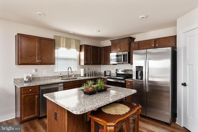 35079 Orchid Ln, Locust Grove, VA 22508 - kitchen with appliances with stainless steel finishes, a sink, light stone countertops, dark wood finished floors, and a center island