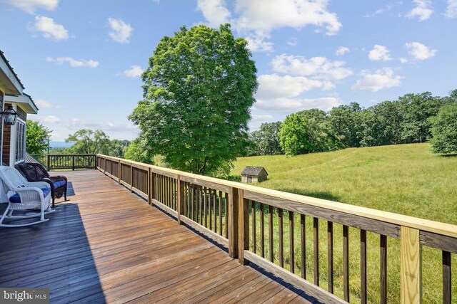 wooden terrace with a yard