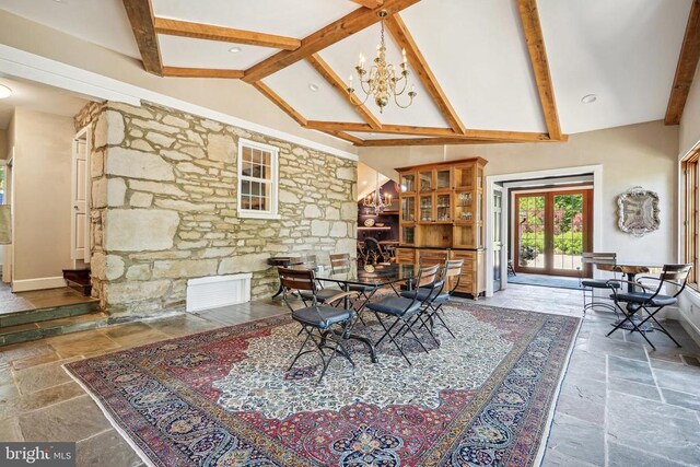 dining area with stone tile flooring, high vaulted ceiling, beam ceiling, a chandelier, and french doors