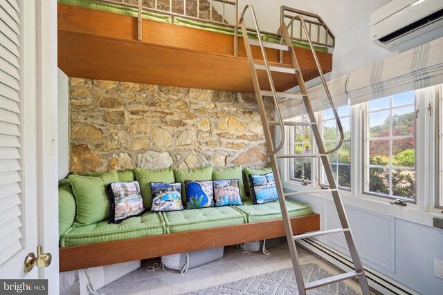 sunroom / solarium featuring a wall unit AC and baseboard heating