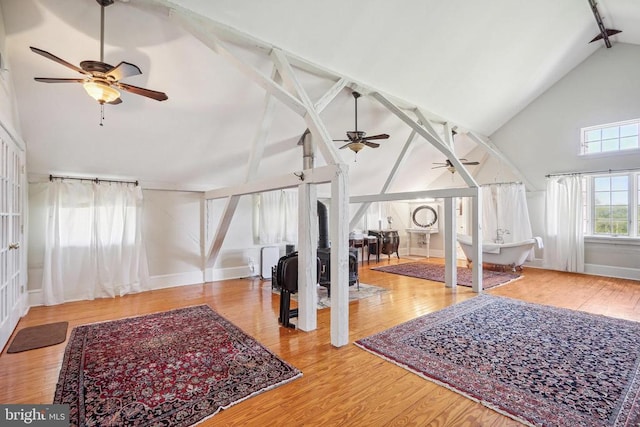 additional living space featuring ceiling fan, high vaulted ceiling, beamed ceiling, wood finished floors, and baseboards