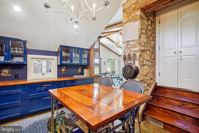 dining area with a chandelier and lofted ceiling