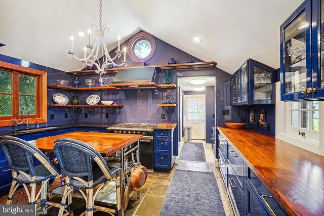 kitchen featuring butcher block countertops, stainless steel range, open shelves, extractor fan, and a chandelier