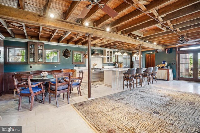 dining space featuring ceiling fan and wood ceiling