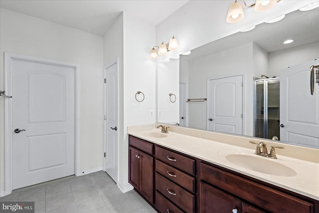 6607 Golden Pheasant Run, Fredericksburg, VA 22407 - bathroom featuring double vanity, tile patterned floors, a shower stall, and baseboards