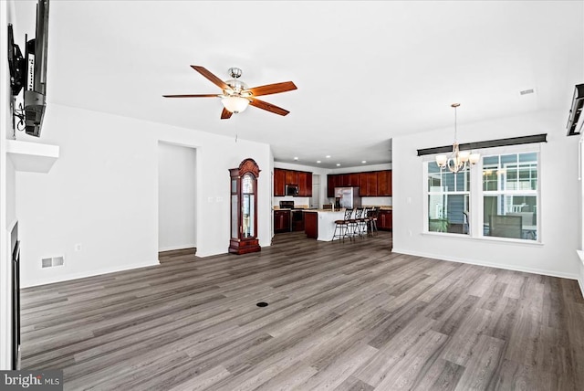 6607 Golden Pheasant Run, Fredericksburg, VA 22407 - unfurnished living room with a chandelier, wood finished floors, a ceiling fan, recessed lighting, and baseboards