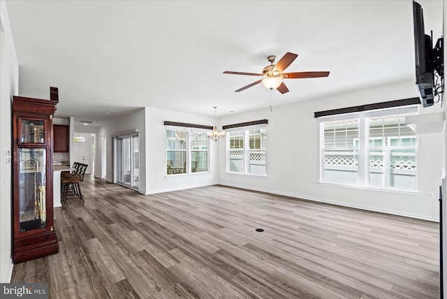 6607 Golden Pheasant Run, Fredericksburg, VA 22407 - unfurnished living room with ceiling fan, wood finished floors, a chandelier, and baseboards