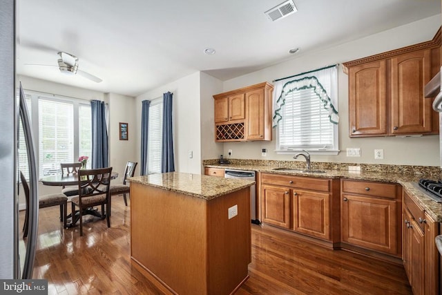 10205 Iverson Ave, Fredericksburg, VA 22407 - kitchen with stainless steel appliances, a sink, dark wood finished floors, a center island, and light stone countertops
