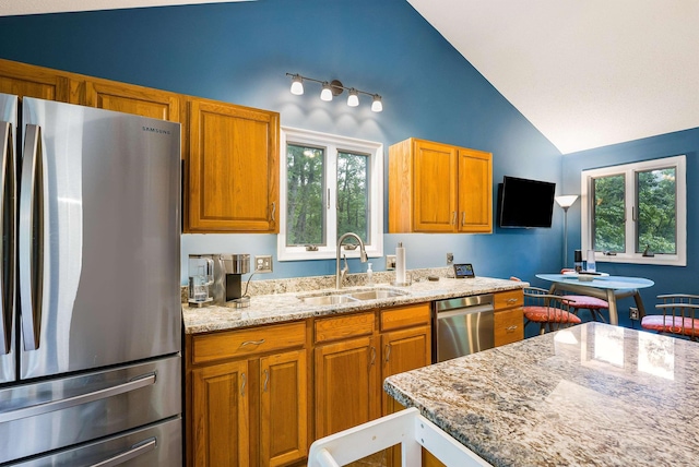 4056 Palmer Rd, Mcgaheysville, VA 22840 - kitchen with appliances with stainless steel finishes, lofted ceiling, light stone counters, and brown cabinetry