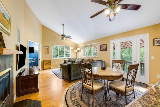 4056 Palmer Rd, Mcgaheysville, VA 22840 - dining area featuring ceiling fan, light wood-style floors, a fireplace, french doors, and high vaulted ceiling