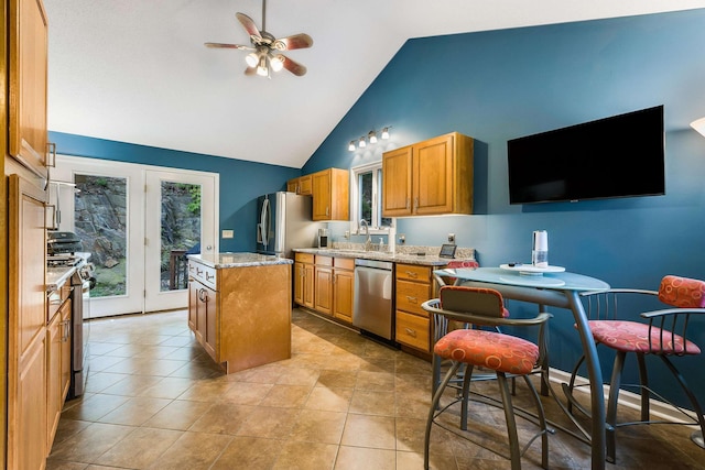 4056 Palmer Rd, Mcgaheysville, VA 22840 - kitchen with stainless steel appliances, a kitchen island, ceiling fan, high vaulted ceiling, and brown cabinetry