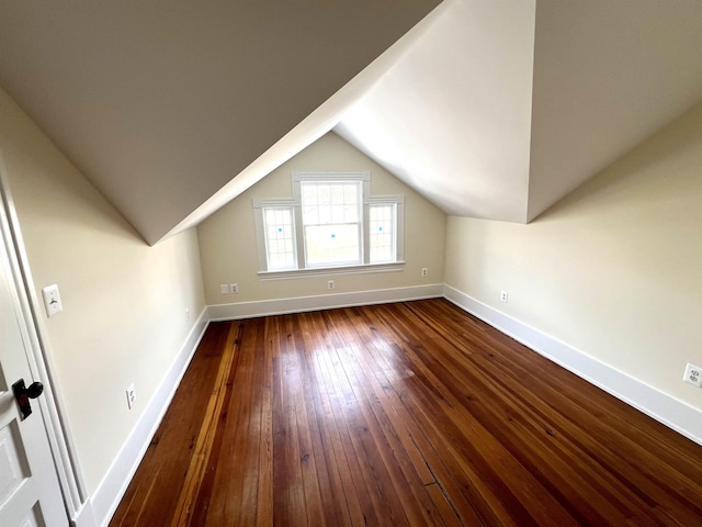 additional living space with lofted ceiling and dark hardwood / wood-style floors