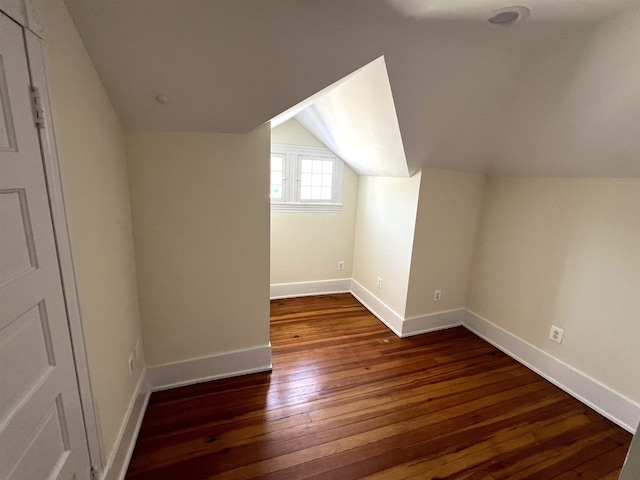 additional living space with lofted ceiling and dark hardwood / wood-style floors