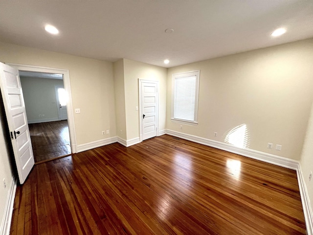 spare room featuring dark hardwood / wood-style flooring