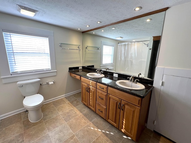 bathroom with vanity, a textured ceiling, a shower with curtain, and toilet