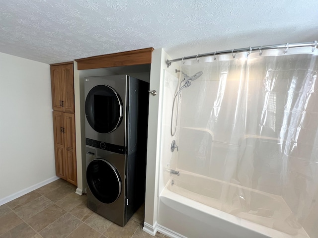 bathroom with shower / tub combo with curtain, stacked washer / dryer, and a textured ceiling