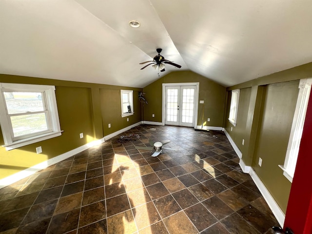 interior space with vaulted ceiling, ceiling fan, and french doors