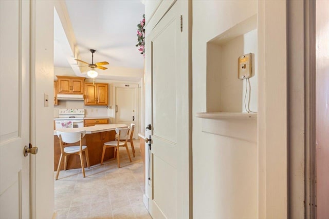 419 College Cir, Staunton, VA 24401 - kitchen with white electric range, under cabinet range hood, a kitchen bar, light countertops, and a ceiling fan