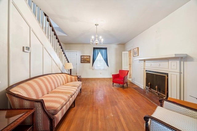 419 College Cir, Staunton, VA 24401 - living room with stairs, wood finished floors, a chandelier, a fireplace, and baseboards