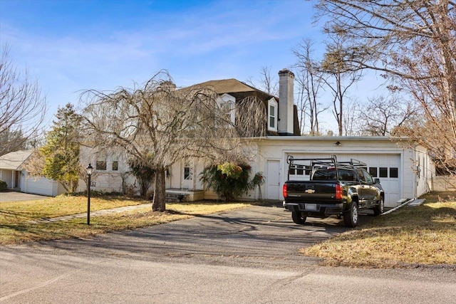 419 College Cir, Staunton, VA 24401 - view of front of house with driveway, a garage, and a chimney