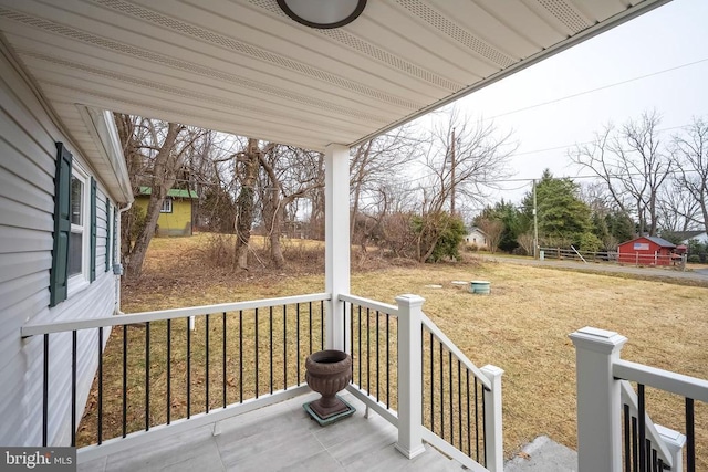 deck with covered porch and a yard
