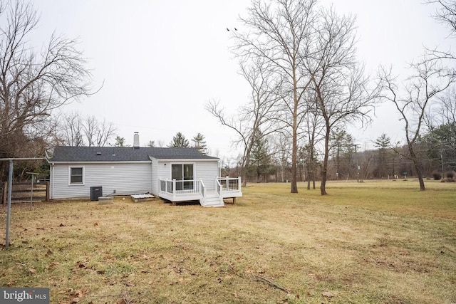 back of house featuring a deck and a chimney