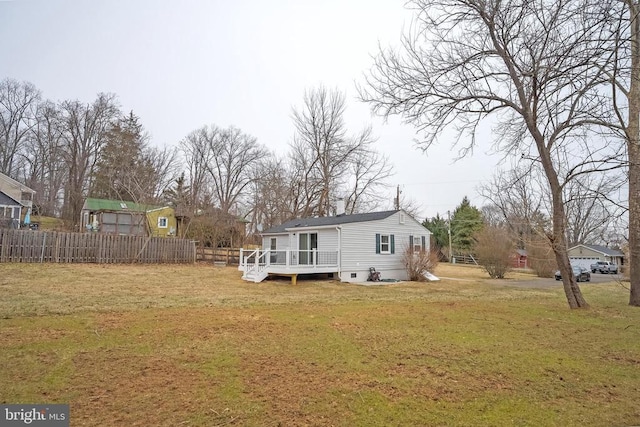 rear view of house featuring a deck and crawl space