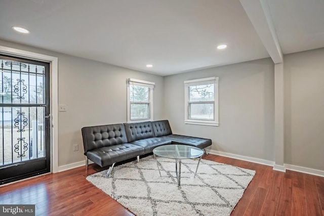living room with baseboards, wood finished floors, and recessed lighting