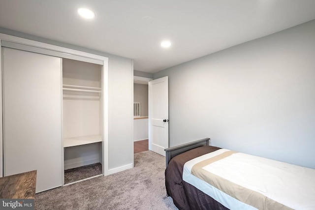 carpeted bedroom featuring recessed lighting, baseboards, and a closet
