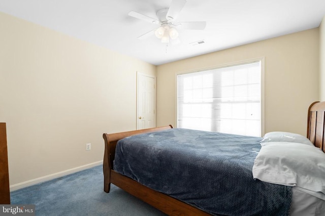 carpeted bedroom featuring a ceiling fan, visible vents, and baseboards