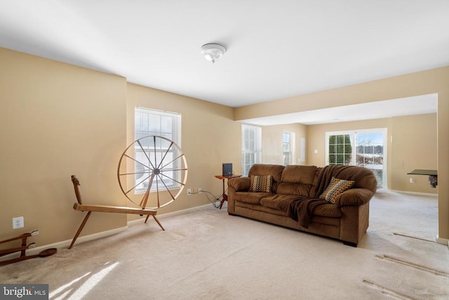 living area with carpet flooring and baseboards