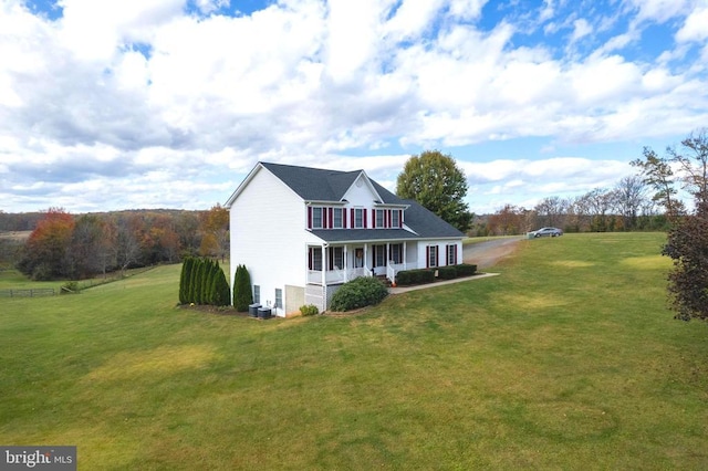 exterior space featuring covered porch and a yard