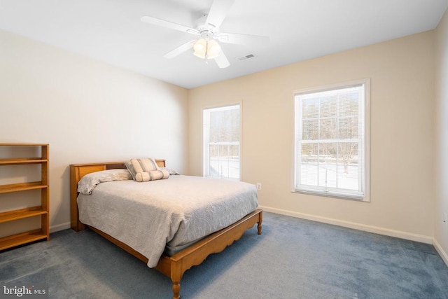 carpeted bedroom featuring visible vents, ceiling fan, and baseboards