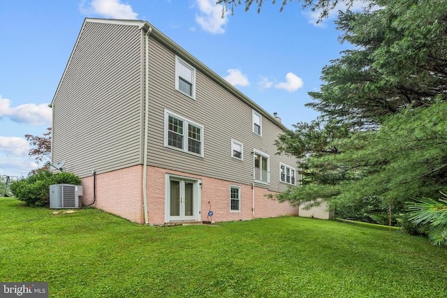  - rear view of property with french doors, a yard, and brick siding