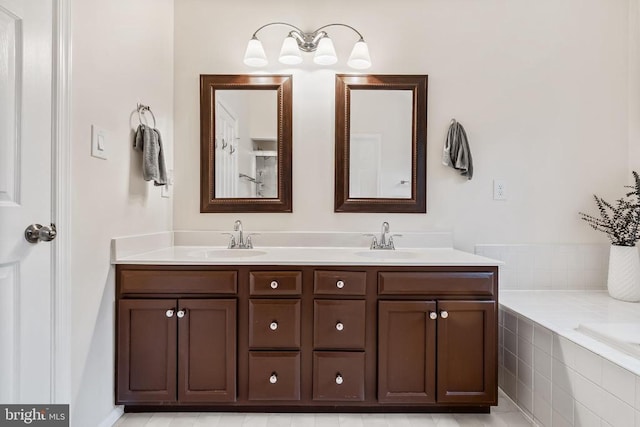  - bathroom with double vanity and tiled tub